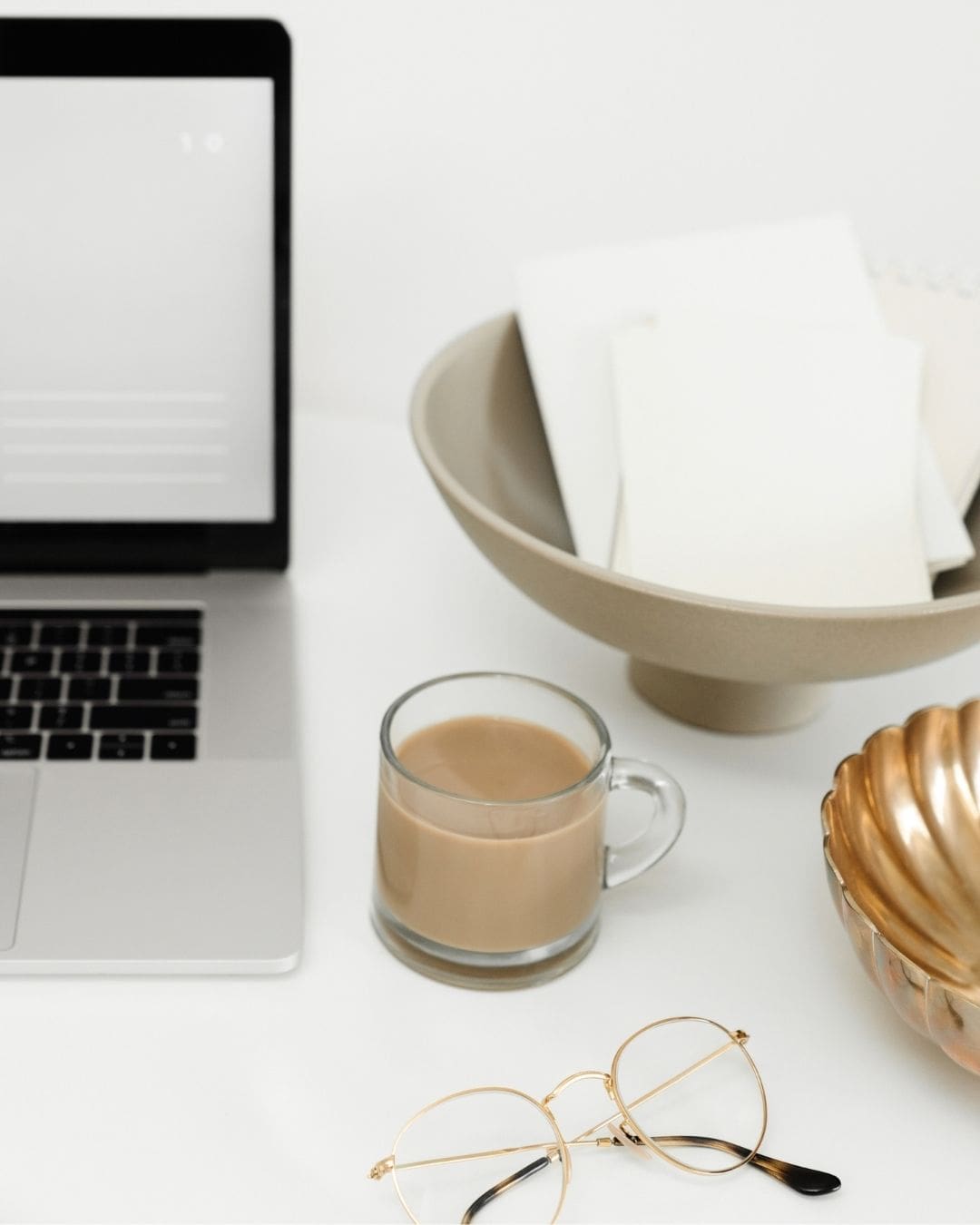Interior designer desk reviewing website pages and project photos at a desk