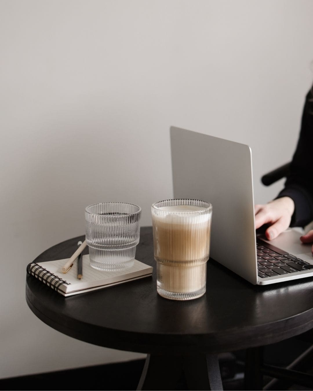 Interior designer working on her Showit website on a laptop